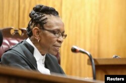 FILE - Judge Thokozile Masipa delivers judgment during the appeal by prosecutors against the verdict and sentence of Oscar Pistorius in the North Gauteng High Court in Pretoria, Dec. 10, 2014.