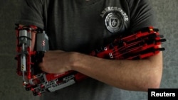 David Aguilar poses with his prosthetic arm built with Lego pices during an interview with Reuters in Sant Cugat del Valles, near Barcelona, Spain, on February 4, 2019. (Reuters/Albert Gea)