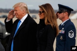 President-elect Donald Trump salutes as he and his wife Melania arrive at Andrews Air Force Base, Md., Thursday, Jan. 19, 2017, ahead of Friday's inauguration. (AP Photo/Evan Vucci)