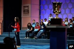 Melodie Loya, 12, of Bainbridge, N.Y., spells her word out in her hand while competing in the 90th Scripps National Spelling Bee in Oxon Hill, Md., Thursday, June 1, 2017. (AP Photo/Jacquelyn Martin)