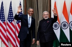 FILE - U.S. President Barack Obama and India's Prime Minister Narendra Modi, right, wave during a photo opportunity ahead of their meeting at Hyderabad House, New Delhi, Jan. 25, 2015.