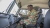 FILE - A Zambian army soldier is seen inside a military truck as other patrol the Chawama Compound in Lusaka on Aug. 3, 2021.