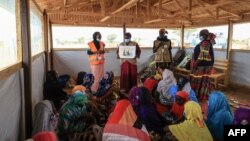 FILE - Women and young girls attend a class in Maroua, Cameroon, on April 28, 2022. Some 30,000 Cameroonian women took to the streets in Yaounde on International Women's Day, March 8, 2024, to call for educational, economic and social equality.