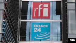 FILE - The headquarters of French national audiovisual media company group France Medias Monde (FMM), displays signage for Radio France Internationale (RFI) and France 24, in Issy-les-Moulineaux, near Paris, April 9, 2019.