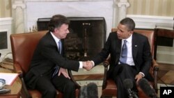 President Barack Obama shakes hands with Colombian President Juan Manuel Santos, Thursday, April 7, 2011, in the White House
