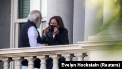 Wakil Presiden AS Kamala Harris (kanan) berbincang dengan Perdana Menteri India Narendra Modi di balkoni dari gedung kantor Eisenhower Eksekutif di kompleks Gedung Putih di Washington, AS, pada 23 September 2021. (Foto: Reuters/Evelyn Hockstein)