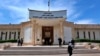 FILE - People walk outside Iraqi Criminal Court in Baghdad's Karkh district, Iraq, May 5. 