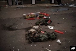 The bodies of unidentified men, arranged in a Z, a symbol of the Russian invasion, lie near a village on the outskirts of Kharkiv, Ukraine, May 2, 2022.