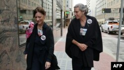 Catherine Berthet, left, from France, and Nadia Milleron from the U.S., arrive for a hearing on the March 2019 Boeing 737 MAX crashes, at the Federal Court in Fort Worth, Texas, May 3, 2022