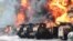 Vehicles are on fire at an oil depot after missiles struck the facility in an area controlled by Russian-backed separatist forces in Makiivka, 15 km (94 miles) east of Donetsk, eastern Ukraine, May 4, 2022. 