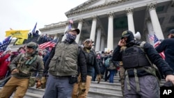 FILE - Members of the Oath Keepers on the East Front of the U.S. Capitol on Jan. 6, 2021, in Washington.