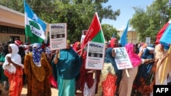 Somali women chant slogans and hold placards as they protest against Somali Islamist group Al-Shabaab at General Kahiye Police Academy in Mogadishu on Jan. 2, 2020. 