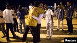 African migrants react after hearing the Israel's high court decision outside Holot open detention center in Israel's southern Negev desert, Sept. 22, 2014. 