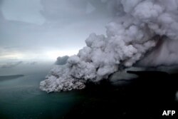 This aerial picture taken on Dec. 23, 2018 by Bisnis Indonesia shows the Anak (Child) Krakatoa volcano erupting in the Sunda Straits off the coast of southern Sumatra and the western tip of Java.