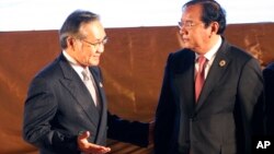 Thailand's Foreign Minister Don Pramudwinai, left, talks to Cambodian Foreign Minister Prak Sokhon after the opening ceremony of the 49th Association of Southeast Asian Nations (ASEAN) Foreign Ministers' Meeting in Vientiane, Laos, Sunday, July 24, 2016. 