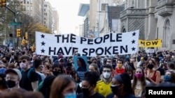 FILE - People gather as they celebrate media announcing that Democratic U.S. presidential nominee Joe Biden has won the 2020 U.S. presidential election, in Philadelphia, Pennsylvania, Nov. 7, 2020.