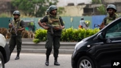 Sri Lankan army soldiers man a check point outside the prime minister's residence in Colombo, Sri Lanka, May 10, 2022.