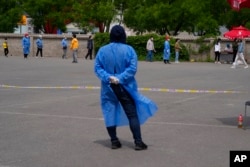 Residents line up for mass COVID-19 test in Beijing, May 9, 2022.