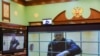 Russian opposition leader Alexei Navalny is seen on screens via a video link from the IK-2 corrective penal colony in Pokrov during a court hearing to consider an appeal against his prison sentence in Moscow, May 24, 2022. 