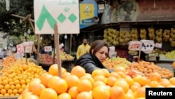 FILE - A woman shops at a fruit and vegetable market in Cairo, Egypt, March 22, 2022.