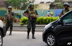 Sri Lankan army soldiers man a check point outside the prime minister's residence in Colombo, Sri Lanka, May 10, 2022.