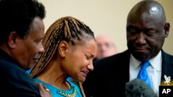 Kamilah Whitfield, center, a granddaughter of Ruth Whitfield, a victim of shooting at a supermarket, speaks with members of the media during a news conference in Buffalo, N.Y., Monday, May 16, 2022. (AP Photo/Matt Rourke)