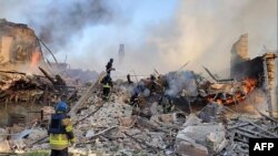 This handout photograph released by Ukrainian State Emergency Service on May, 8, 2022, shows Ukrainian firefighters putting out a fire after Russian missiles hit a school in Bilohorivka, May, 7, 2022. (AFP photo / Ukrainian State Emergency Service)