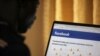 FILE - A man opens the Facebook page on his computer in Abuja, Nigeria, March 19, 2020. Meta, the company that owns Facebook, is hosting its second Africa Day campaign.