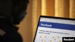 FILE - A man opens the Facebook page on his computer in Abuja, Nigeria, March 19, 2020. Meta, the company that owns Facebook, is hosting its second Africa Day campaign.