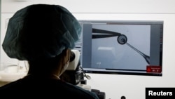 An employee demonstrates the work process before freezing eggs in a Fertility Research lab at Cha Fertility Center in Bundang, South Korea, April 30, 2022. (REUTERS/Heo Ran)