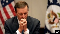FILE: U.S. Senator Chris Murphy of Connecticut listens during a press conference, April 19, 2022.