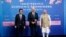 Japanese Prime Minister Fumio Kishida, left, U.S. President Joe Biden and Indian Prime Minister Narendra Modi pose for photos as they arrive at the Indo-Pacific Economic Framework for Prosperity launch event at the Izumi Garden Gallery, May 23, 2022, in Tokyo.