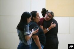 People react outside the Civic Center following a deadly school shooting at Robb Elementary School in Uvalde, Texas Tuesday, May 24, 2022. (AP Photo/Dario Lopez-Mills)