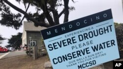 FILE— Signs alert visitors to the severe drought in Mendocino, Calif., on Aug. 4, 2021. California's water usage jumped nearly 19% in March of 2022, during one of the driest months on record, state officials announced, May 10, 2022. 