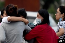 Family members of passengers on board a Twin Otter aircraft operated by Tara Air weep outside the airport in Pokhara, Nepal, May 29, 2022, after the plane with 22 people on board went missing.