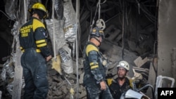 Firefighters and rescue workers remove debris from the ruins of the Saratoga Hotel, in Havana, Cuba, May 8, 2022.