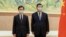 In this photo released by Xinhua News Agency, Chinese President Xi Jinping, right, and Hong Kong Chief Executive-elect John Lee pose for photo before their meeting in Beijing, May 30, 2022.
