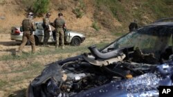 Volunteers from Belarus practice at a shooting range near Warsaw, Poland, May 20, 2022. Belarusians are among those who have answered a call by Ukrainian President Volodymyr Zelenskyy for foreign fighters to join Ukraine in its war against Russian aggress