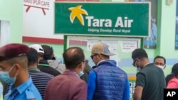 A signage of Tara Airlines is seen behind as a team of climbers prepare to leave for rescue operations from the Tribhuvan International Airport in Kathmandu, Nepal, May 29, 2022.