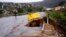 Water from heavy rains runs along a road, which was damaged during previous flooding, in kwaNdengezi near Durban, South Africa, May 22, 2022. 