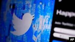 FILE - The Twitter splash page is seen on a digital device, Monday, April 25, 2022, in San Diego. Elon Musk said Friday that his $44-billion deal to buy Twitter was “temporarily on hold.” (AP Photo/Gregory Bull/File)
