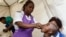 FILE - A Zimbabwean medical staff gives a young boy a vaccine against cholera during a vaccination campaign, in Harare, Zimbabwe, Oct. 5, 2018. Malawi plans to administer the vaccine beginning May 23, 2022, following a rise in cholera cases.