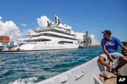 FILE - Boat captain Emosi Dawai looks at the superyacht Amadea where it was docked at the Queens Wharf in Lautoka, Fiji, on April 13, 2022.