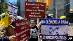 Demonstrators stand outside Manhattan federal court to protest former Honduran President Juan Orlando Hernandez, who pleaded not guilty to drug and weapons charges, May 10, 2022, in New York