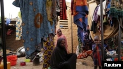 FILE - People, who fled attacks by Islamist militants in northern Burkina Faso are seen at a camp for internally displaced people in Ouagadougou, Burkina Faso, Jan. 29, 2022. 