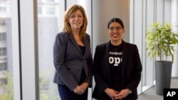 In this image provided by the Office of the Director of National Intelligence, diversity leaders with the Office of the Director of National Intelligence Sherry Van Sloun, left, and Stephanie La Rue pose for a photo in Virginia, on May 12, 2022.