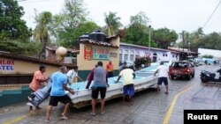 Fishermen pull a boat to higher ground as Hurricane Agatha moves toward the southern coast of Mexico, in Puerto Escondido, Oaxaca state, Mexico, May 30, 2022. 