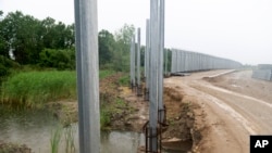 FILE - A view of a steel wall at Evros river, near the village of Poros, at the Greek-Turkish border, Greece, on May 21, 2021. Greek authorities said on May 29, 2022, they are planning a major extension of the wall along the country's border with Turkey.