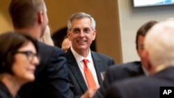 Incumbent Georgia Secretary of State Brad Raffensperger talks with supporters during an election night party Tuesday evening, May 24, 2022, at a small restaurant in Peachtree Corners, Ga.