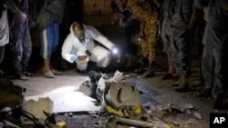 A forensic expert inspects the wreckage of a drone aircraft that Houthi rebels claimed to have shot down, in Sanaa, Yemen, on May 23, 2022.